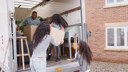 Wall Mural - Family Unloading Furniture From Removal Truck Into New Home