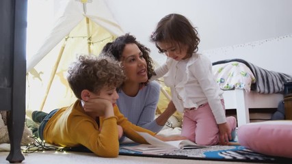 Wall Mural - Single Mother Reading With Son And Daughter In Den In Bedroom At Home