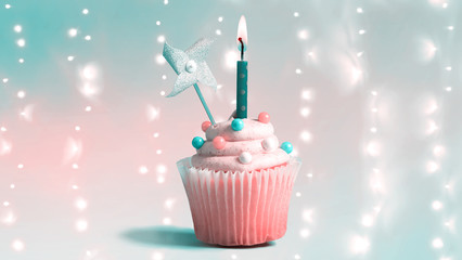 Wall Mural - Celebratory cupcake with a decorative lit candle