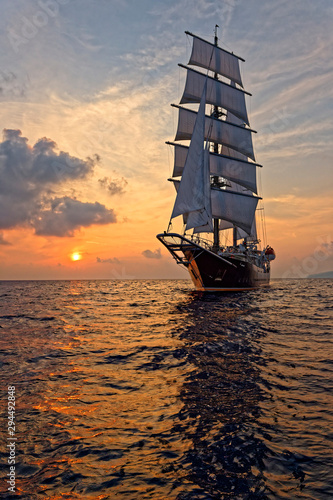 Beautiful sea at sunset and a sailing ship under white sails. Yachting © Alvov