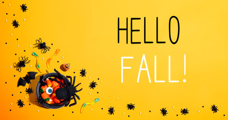 Hello fall message with Halloween decorations and witch cauldron