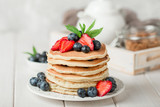 Fototapeta Boho - Classic american pancakes with fresh berry on white wood background. Summer homemade breakfast.