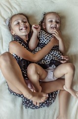 Wall Mural - two girlfriends sisters grimacing