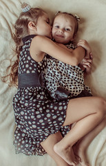 Wall Mural - two sisters girlfriends hugging