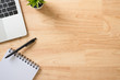 © Chalermpon - Flay lay, Top view office table desk with computer laptop, keyboard, notepad, pen and green plant with copy space background.