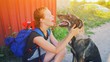© raisondtre - Portrait young hipster woman with backpack kissing dog outdoors Happy pet and attractive girl playing fun Positive human friend emotions, facial expression, feelings Love between people and animal