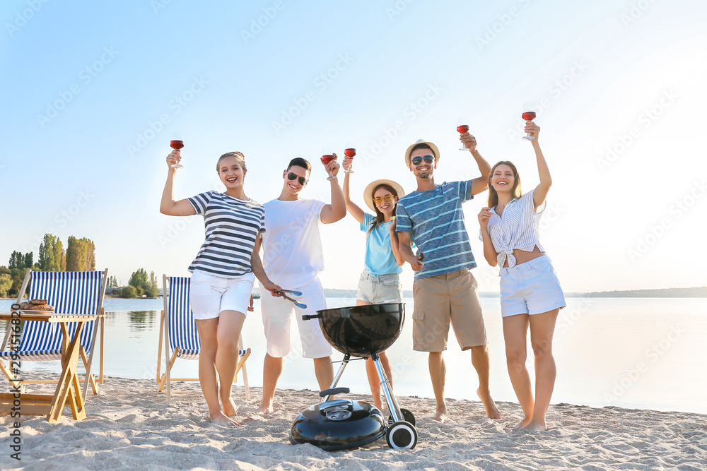 Friends at barbecue party near river