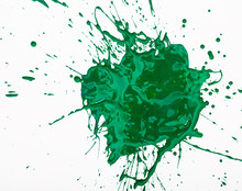 Artistic Image Of Green Paint Spot Spilled On Background Of White Paper