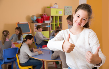 Wall Mural - Portrait of cheerful schoolgirl and children