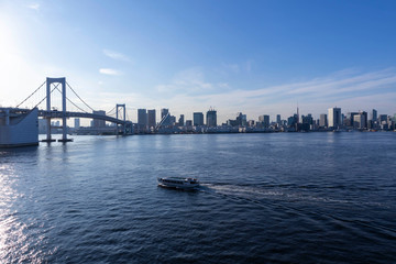 View of the Tokyo Bay during the day from the Rainbow Bridge in Odaiba. Busy waterway with ships. Landscape Orientation.