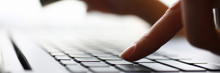 Female arms hold credit card press buttons making transfer closeup. Anti-fraud financial security when entering client discount program number or filling personal credential password login to account