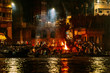 The burning bodies ceremony at holy Dasaswamedh Ghat, near Kashi Vishwanath Temple while raining at night, Varanasi, India.
