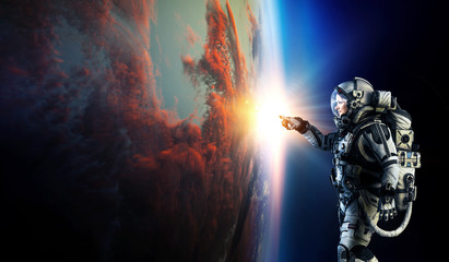 Wall Mural - astronaut and planet, human in space concept