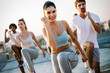 © NDABCREATIVITY - Group of happy fit friends exercising outdoor in city