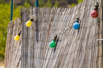 colorful lamps on the reed fence