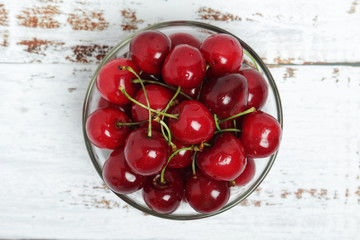 Poster - A small glass bowl with ripe fresh cherry