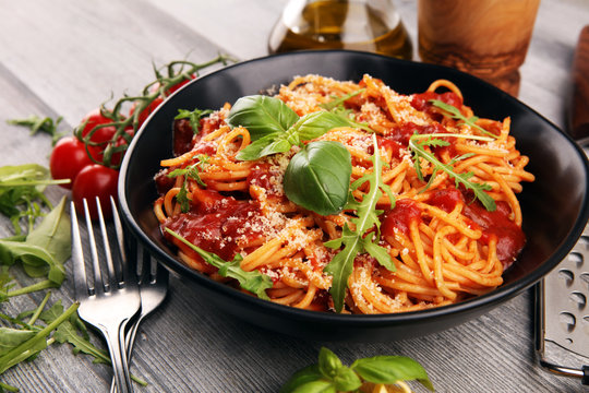 plate of delicious spaghetti bolognaise or bolognese with savory minced beef and tomato sauce garnis