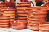 Fototapeta Kwiaty - Clay dishes. Group of brown clay plates. Spanish tableware .
