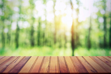 Wall Mural - empty wood table on blur forest background for design product