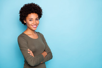 Turned photo of positive cheerful successful girl true leader on her enterprise cross hands wear green pullover outfit isolated over blue color background