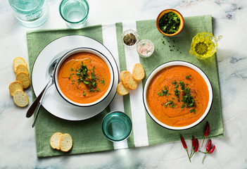 cream soup of red lentils with tomatoes on the table. healthy vegan warming food for the whole family