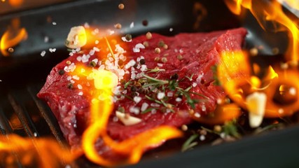 Wall Mural - Super slow motion of falling beef steak into flames. Filmed on high speed cinema camera, 1000 fps.