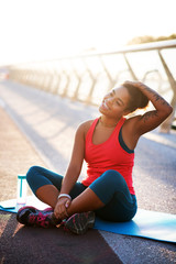 Wall Mural - Dark-skinned woman stretching neck while doing yoga