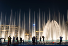 Silhouettes Of People Enjoying The Fountain Show In Dubai At Night, United Arab Emirates