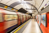 Underground Tube Station with Moving train motion blurred in London, UK