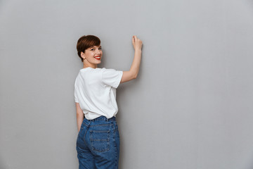 Poster - Image of happy brunette woman smiling and writing on copyspace