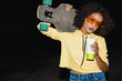 © Drobot Dean - Image of american girl drinking soda and holding skateboard at night