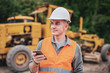 © Pituk - Portrait of caucasian engineers use smartphones in the workplace. Road construction site
