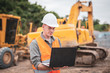 © Pituk - Caucasian young engineer using a laptop on road construction site. Engineer work concept