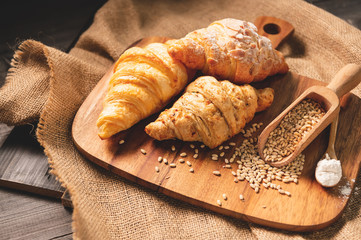 Different kinds of bread with nutrition whole grains on wooden background. Food and bakery in kitchen concept. Delicious breakfast gouemet and meal. Carbohydrate organic food cuisine homemade