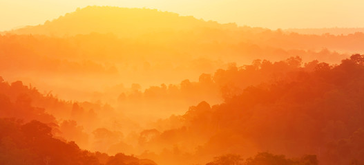 Panoramic scenery of autumn mountain in the morning mist.