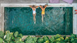 © Alena Ozerova - People relaxing in pool on Bali villa