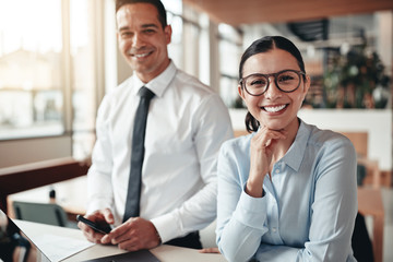 smiling businesswoman working with a colleague in an office