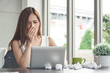 Ofiice syndrome sickness - Asian businesswoman sneezing while working in an office. 