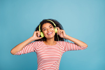 Sticker - Closeup photo of pretty dark skin lady enjoy cool youth music in green earflaps good mood wear casual clothes isolated pastel blue color background