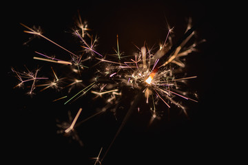 Burning sparklers on a dark background