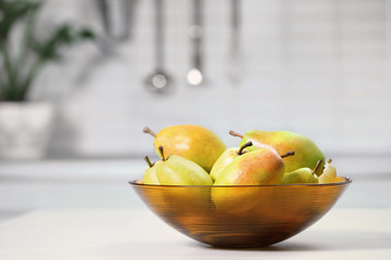 Sticker - Fresh ripe pears on white table in kitchen. Space for text