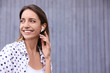 © New Africa - Young woman with wireless headphones listening to music near grey wall. Space for text