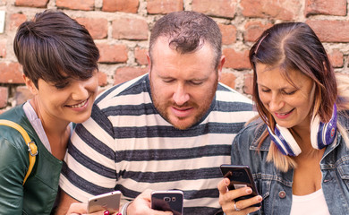 Canvas Print - group of friends are watching the smartphone together