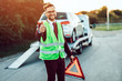 Elegant middle age business man is happy and satisfied with fast towing service for help on the road. He showing thumb up. Roadside assistance concept.