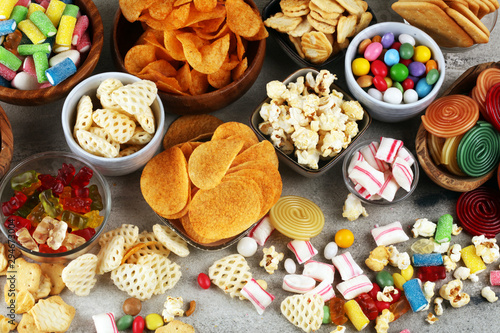 Fotografía Salty snacks. Pretzels, chips, crackers and candy sweets on table
