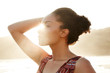 © Trinette Reed/Stocksy - Profile of mixed race woman backlit by the sun at the beach