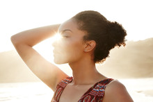 Profile Of Mixed Race Woman Backlit By The Sun At The Beach
