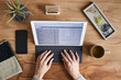 © Trinette Reed/Stocksy - Overhead shot of a small business owner typing on a tablet computer