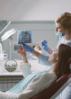 © AD Photography/Stocksy - Young woman discussing her jaw x-ray with her dentist