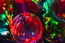 Abstract Shot Of Glass Ball On Colorful Holographic Backdrop